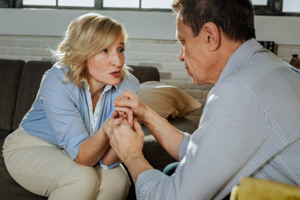 istock Serious gesture. Desperate old couple having problems and discussing them together while holding each other hands 1136033219