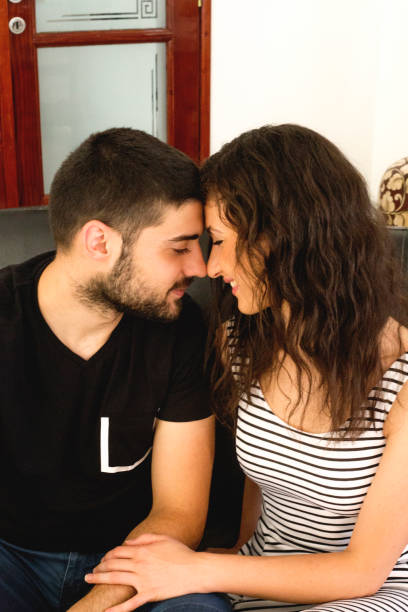 istock Happy couple hugging and smiling during therapy session 1136033336
