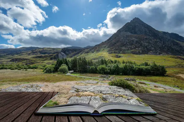 Beautiful landscape image of countryside around Llyn Ogwen in Snowdonia during early Autumn coming out of pages of open story book