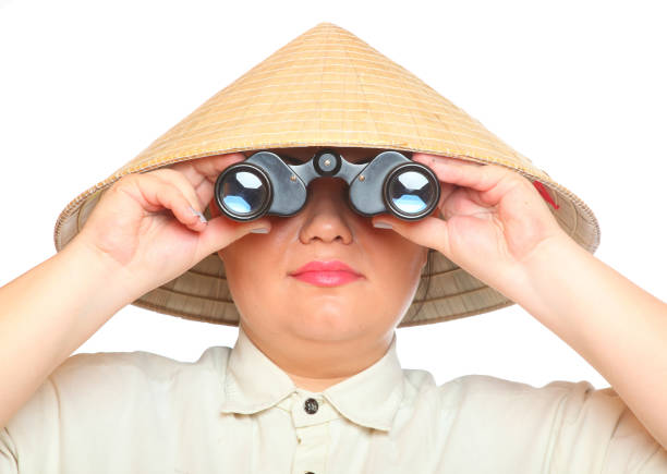 istock Asian traveler woman exploring looking through binoculars. 1136035155