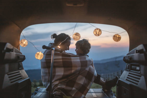 Fun in a car trunk Mother and son having fun in car trunk family camping stock pictures, royalty-free photos & images