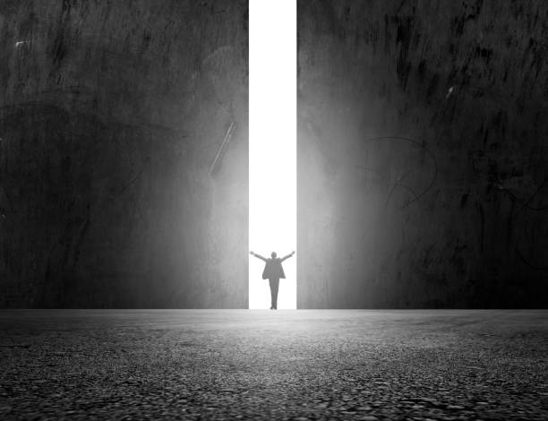 istock Man stands in the light of opening 1136036772
