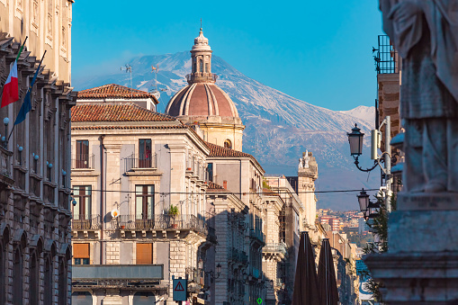 Dome of church and the main street via Etnea, volcano Etna on the background, Catania , Sicily, Italy.