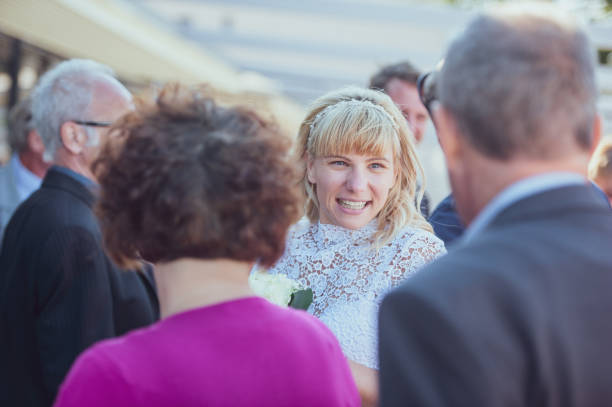 istock Cheerful Bride Socializing With Guests After Wedding Ceremony 1136037867