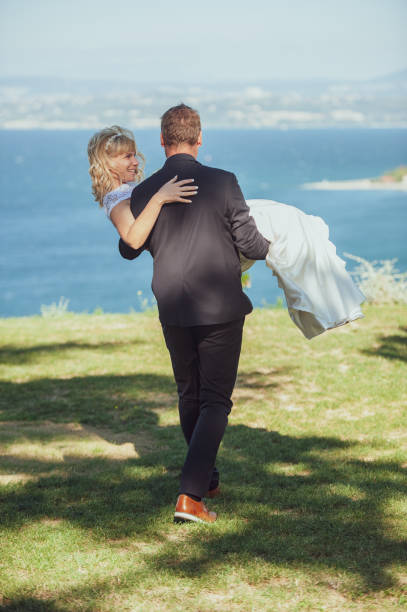 istock Husband Carrying Wife After the Wedding 1136037874