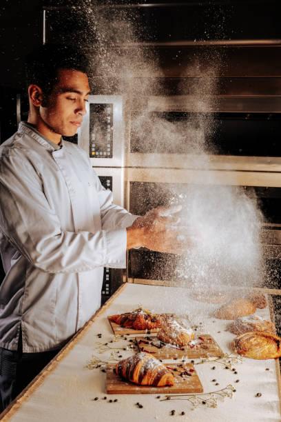 istock Baker spilling sugar powder over croissants and puffs 1136040081