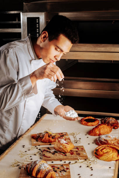 istock Professional baker feeling good while finishing decoration of pastry 1136040087