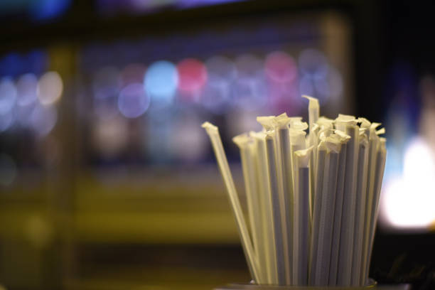 Bunch of straws standing in a cup.