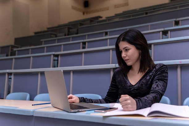 istock Woman working on laptop in a classroom 1136040363