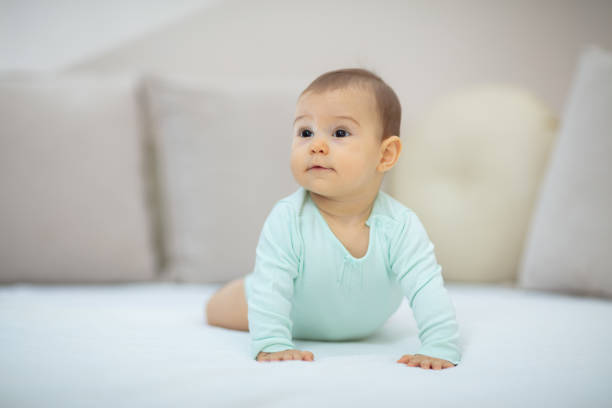 istock Playful baby lying down in bed 1136041538
