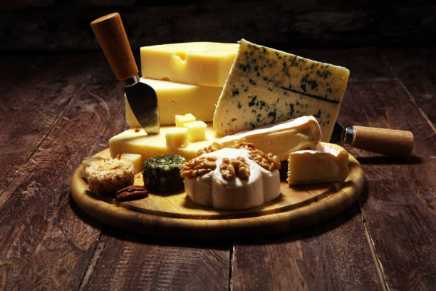 istock Cheese plate served with figs, various cheese on a platter on wood 1136041989