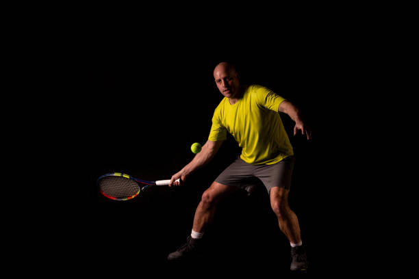 istock Tennisplayer in front of black background 1136042677