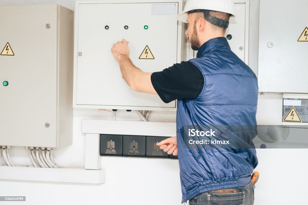 electrician-opens-a-large-electric-box-engineer-checks-the-electrical