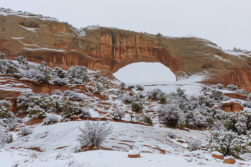 the scenic Wilson's arch south of Moab Utah during a winter snow