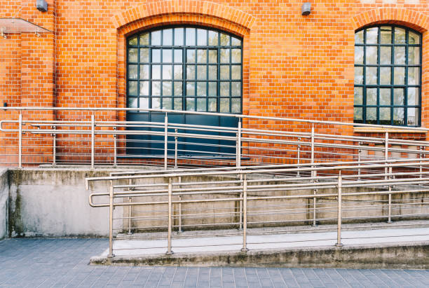 Concrete ramp way with stainless steel handrail for support wheelchair disabled people