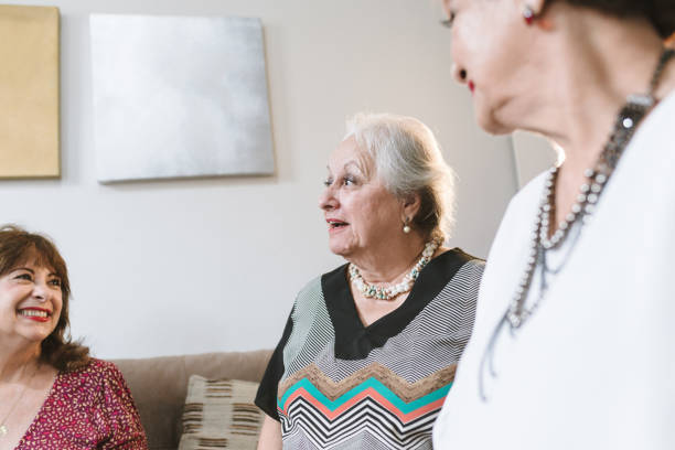 istock elderly women talking at home 1136043561