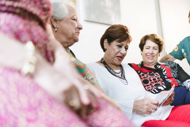 istock Senior women having fun looking at old pictures 1136043569
