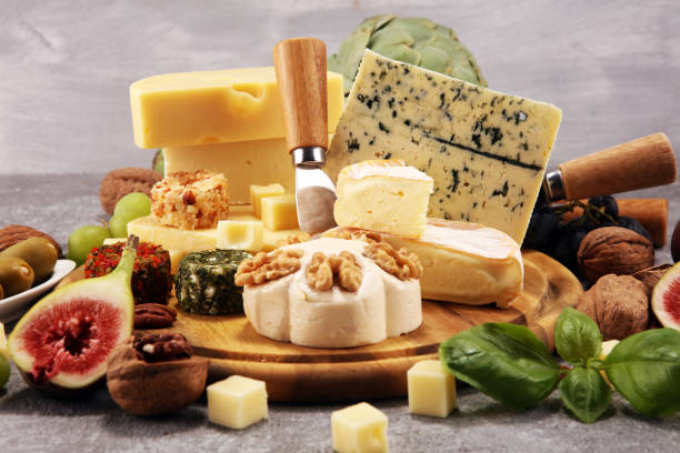 istock Cheese plate served with figs, various cheese on a platter on wood 1136043675