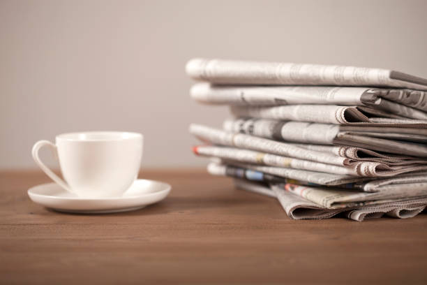 istock newspaper coffee cup and eyeglasses over desk 1136045879
