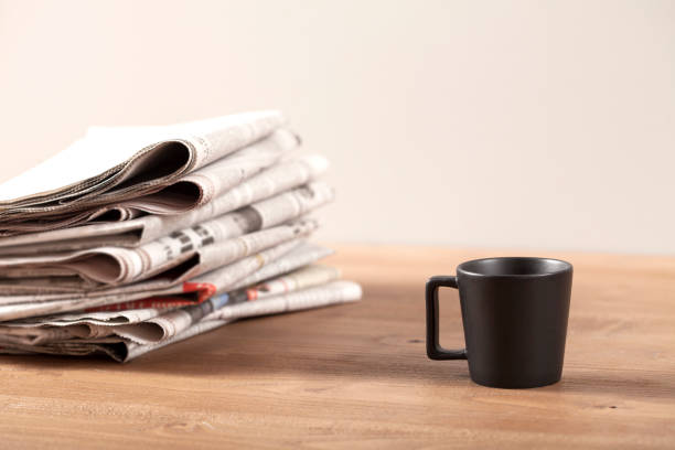 istock newspaper coffee cup and eyeglasses over desk 1136045884