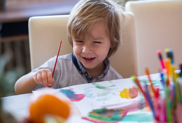 istock cute boy is painting 1136051411