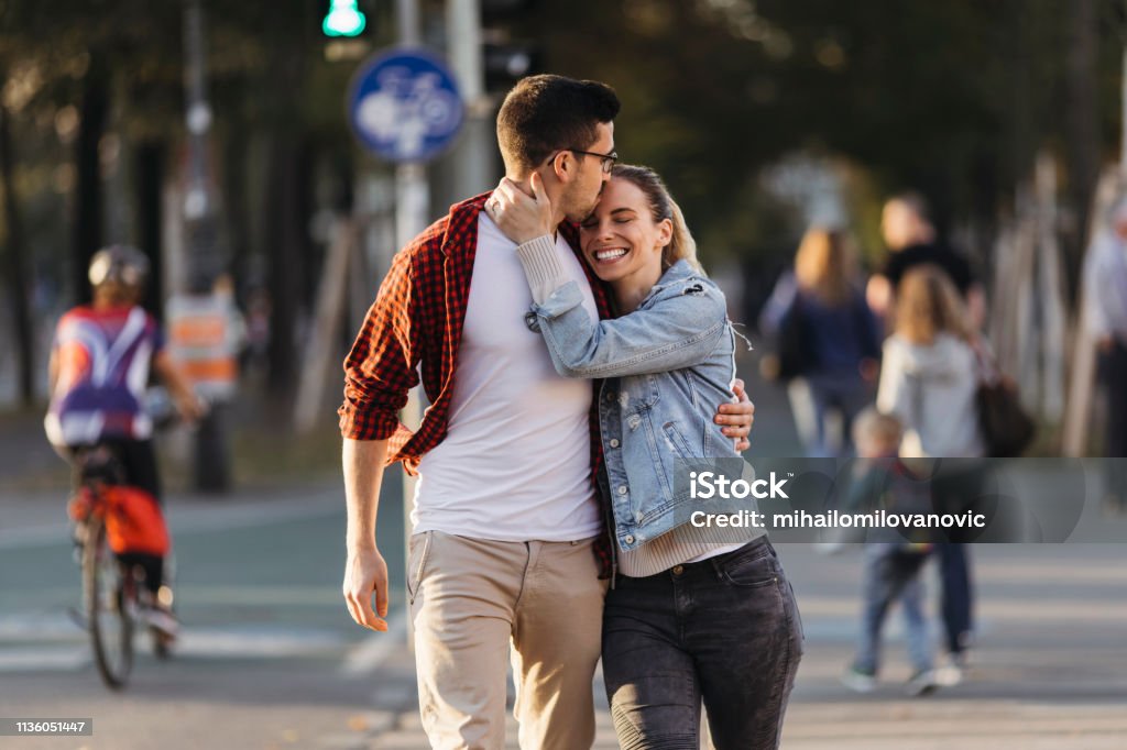 Cute girl with a boyfreind Cute girl holding boys hand while he is kissing her head 20-29 Years Stock Photo