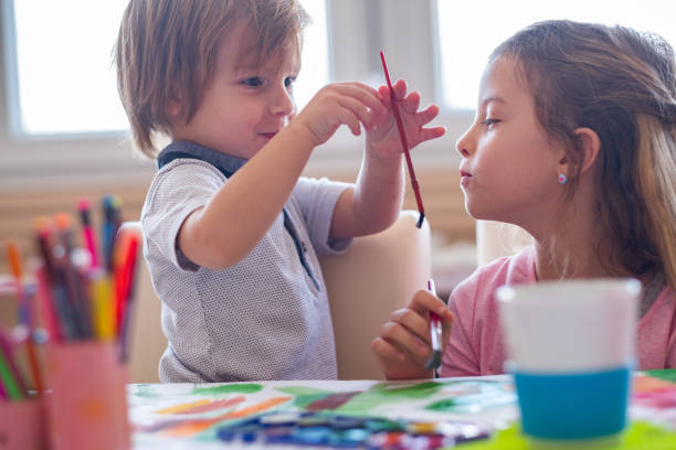 istock two kids painting togeder 1136052275