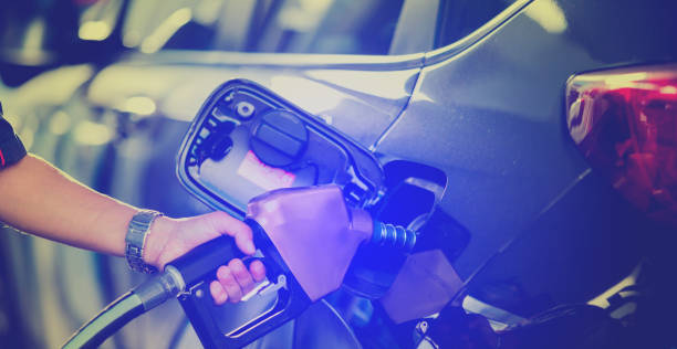istock Hand refilling the car with fuel at the refuel station 1136053237