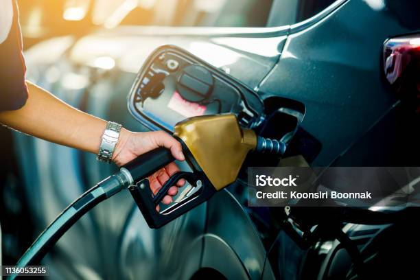 Hand Refilling The Car With Fuel At The Refuel Station Stock Photo - Download Image Now