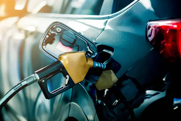 Photo of Hand refilling the car with fuel at the refuel station