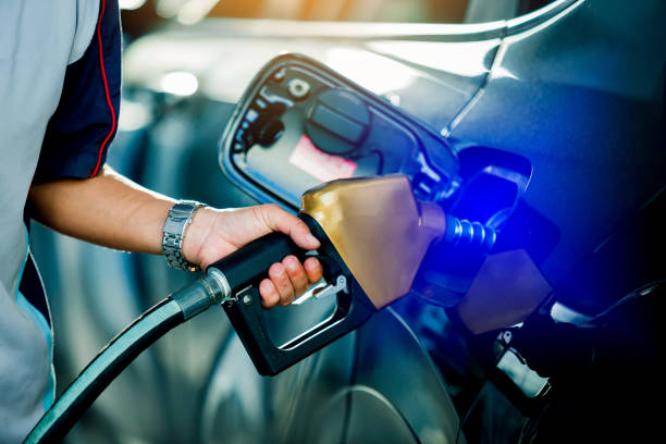 istock Hand refilling the car with fuel at the refuel station 1136053277
