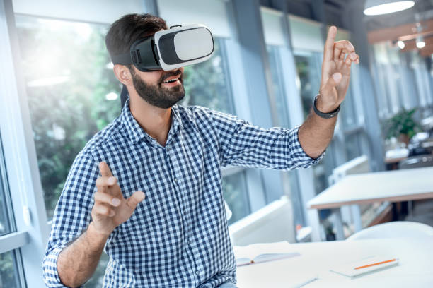 istock Business man using virtual reality headset in the office 1136056183