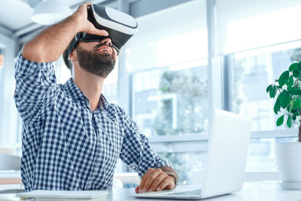 istock Business man using virtual reality headset in the office 1136056189