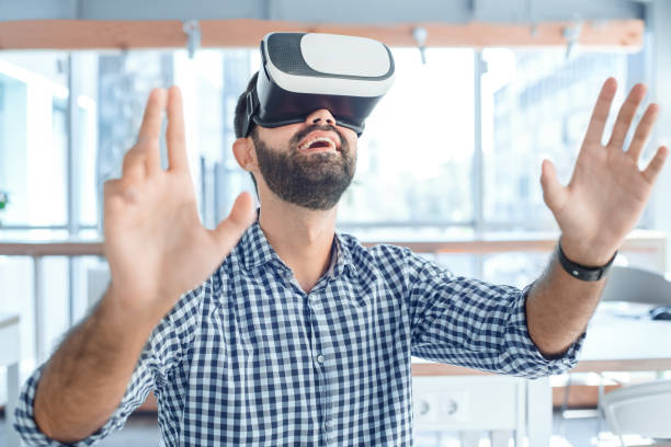 istock Business man using virtual reality headset in the office 1136056209