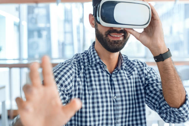 istock Business man using virtual reality headset in the office 1136056211