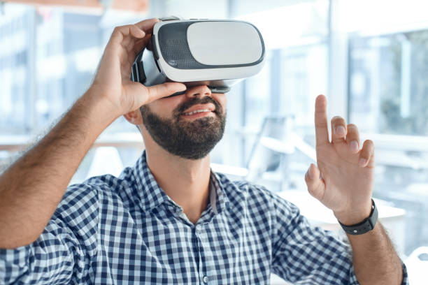 istock Business man using virtual reality headset in the office 1136056213