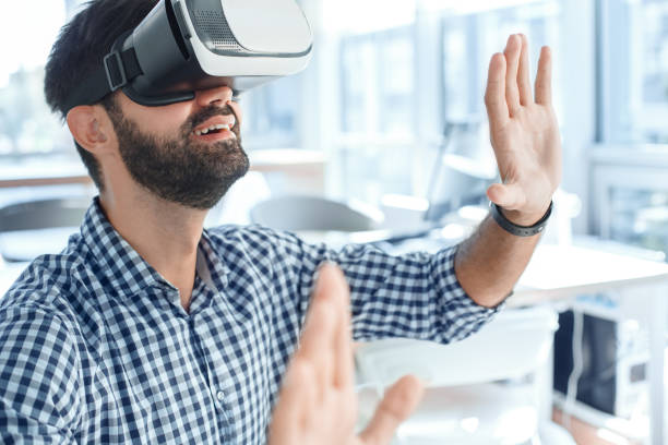 istock Business man using virtual reality headset in the office 1136056214