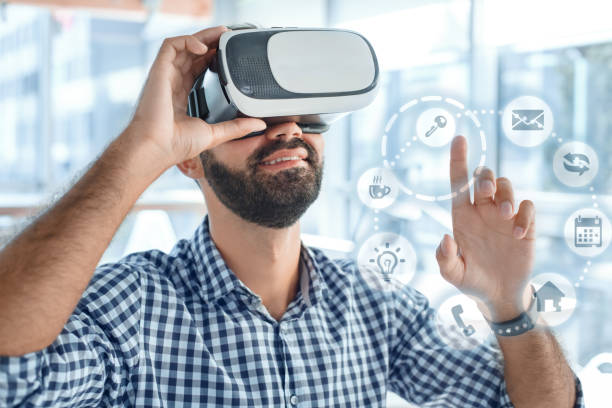 istock Business man using virtual reality headset in the office 1136056215