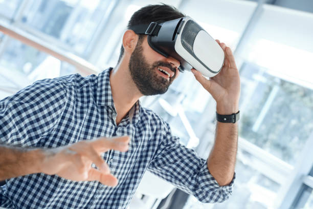 istock Business man using virtual reality headset in the office 1136056219