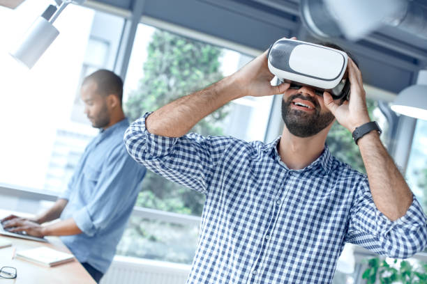 istock Business people using virtual reality headset in the office 1136056279