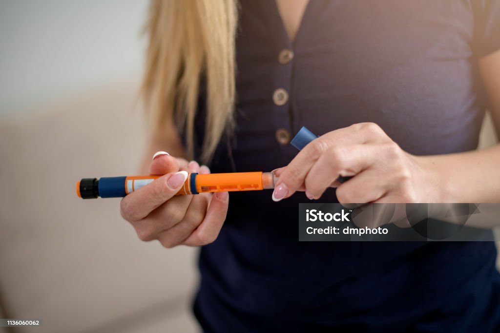 Injection with insulin pen Insulin Stock Photo