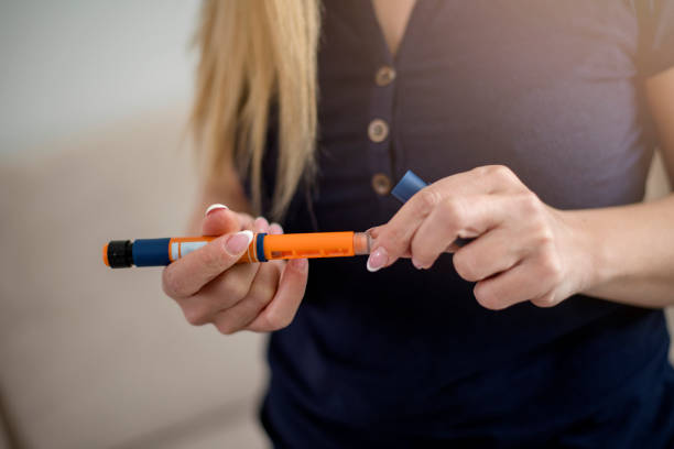 Injection with insulin pen stock photo