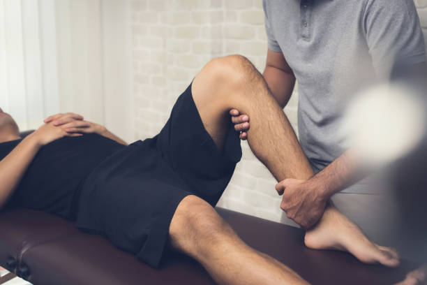 istock Physiotherapist treating athlete male patient 1136060794
