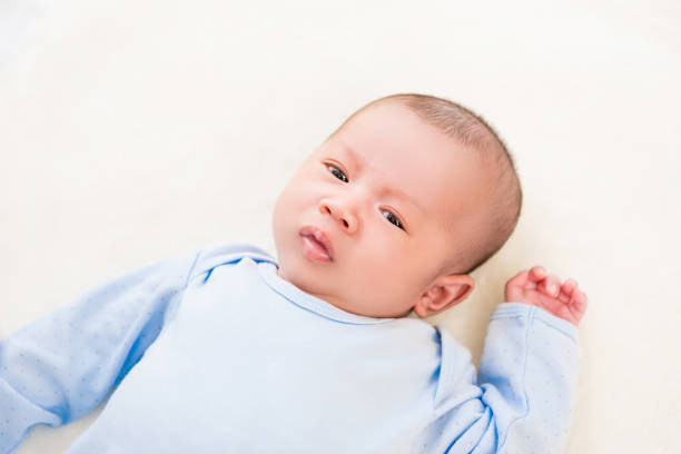 istock Cute newborn baby lying on white sheet 1136060817