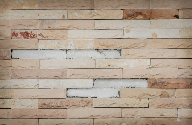 istock Decorative texture old brown sand stone on concrete wall with small gecko for background 1136065069