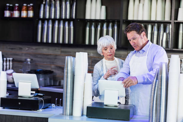istock Workers in coffee shop at cash register 1136072366