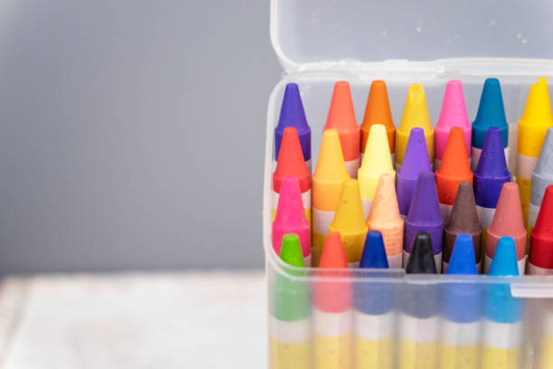 istock colorful crayons in the transparent box.selective focus shot and grain effect 1136078881