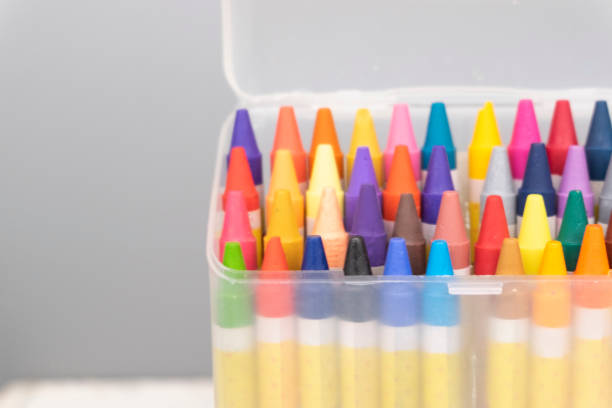 istock colorful crayons in the transparent box.selective focus shot and grain effect 1136078902