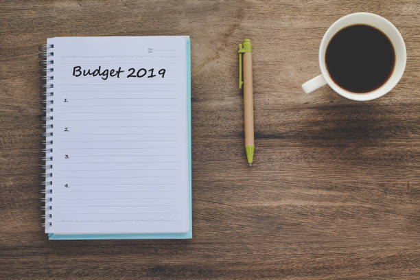 istock Budget 2019 Plan text on book note with cup of coffee, pen and smartphone. 1136079971