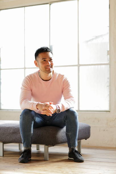 istock Portrait of a man sitting on sofa 1136080233
